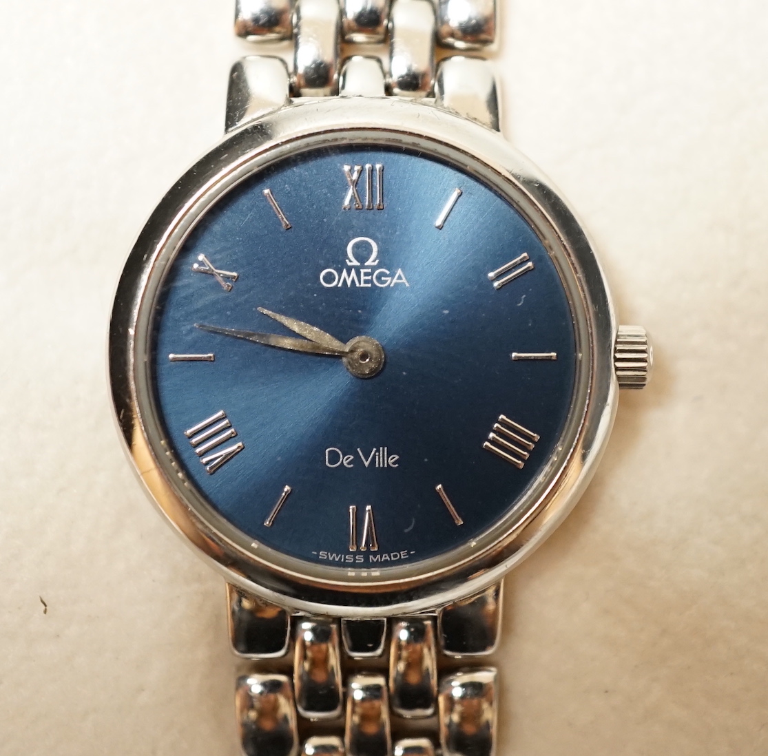 A lady's 1990's stainless steel Omega De Ville quartz wrist watch, with blue dial, box and papers.